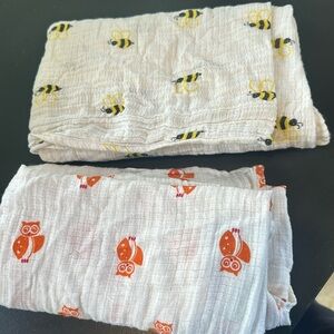 Two muslin swaddle blankets